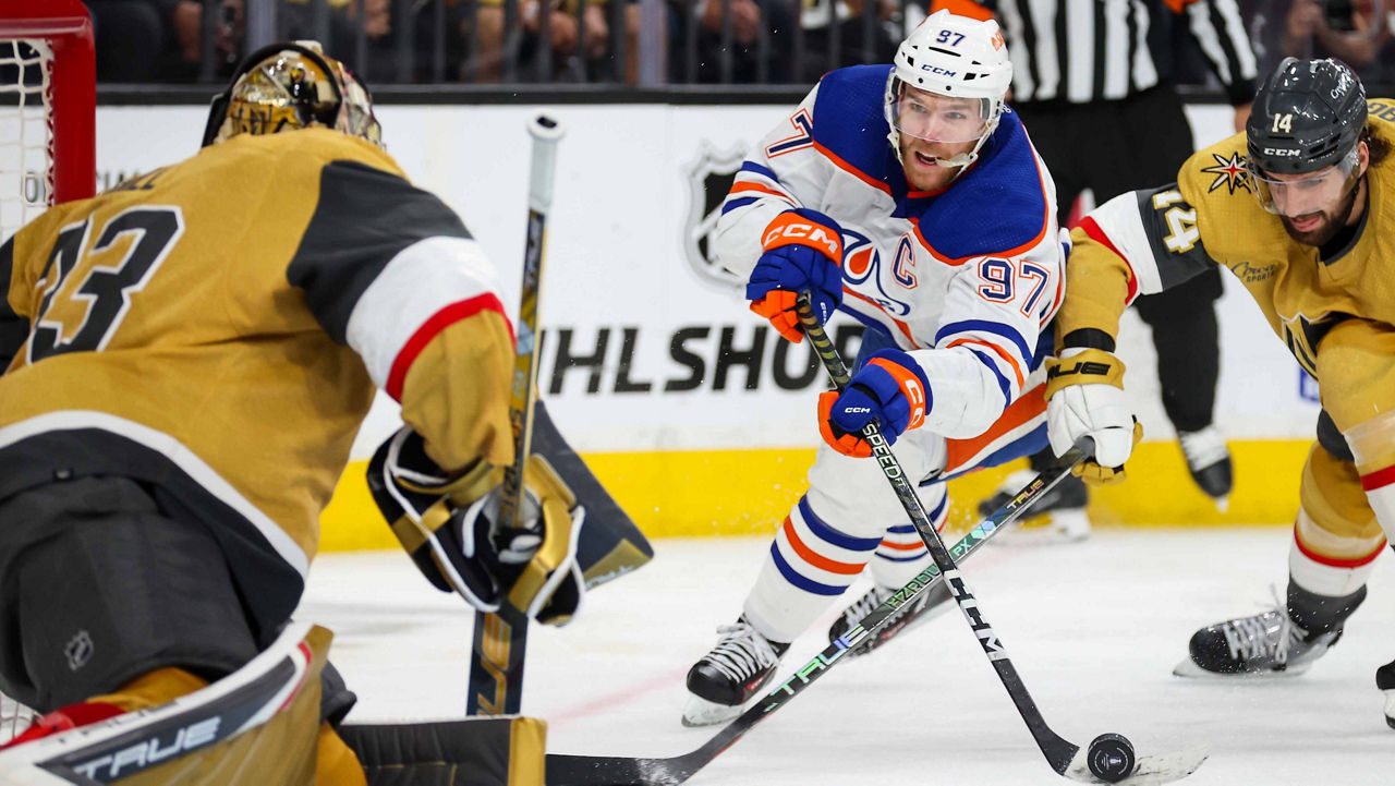 Connor McDavid shooting the puck at the goalie for Vegas