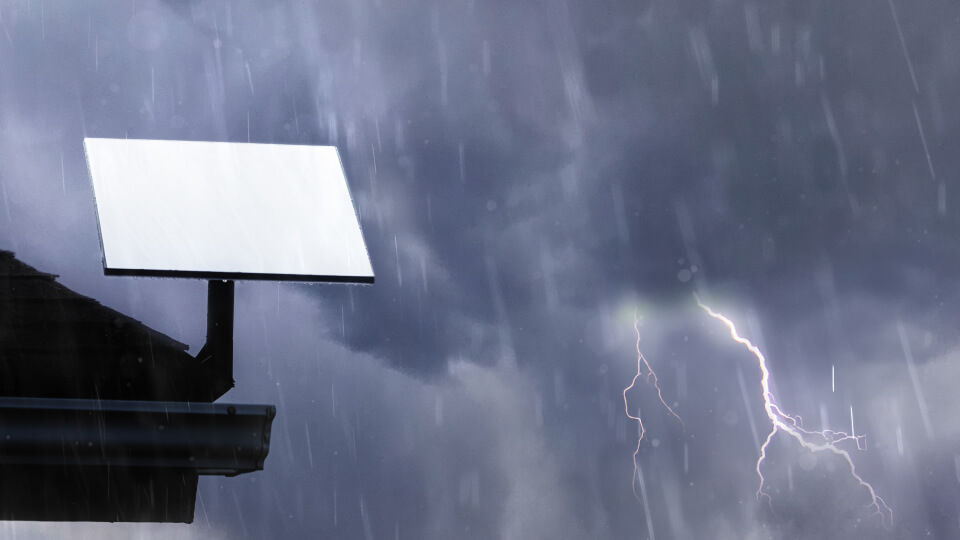 A roof-mounted Starlink dish operating in heavy rain and a lightning storm.